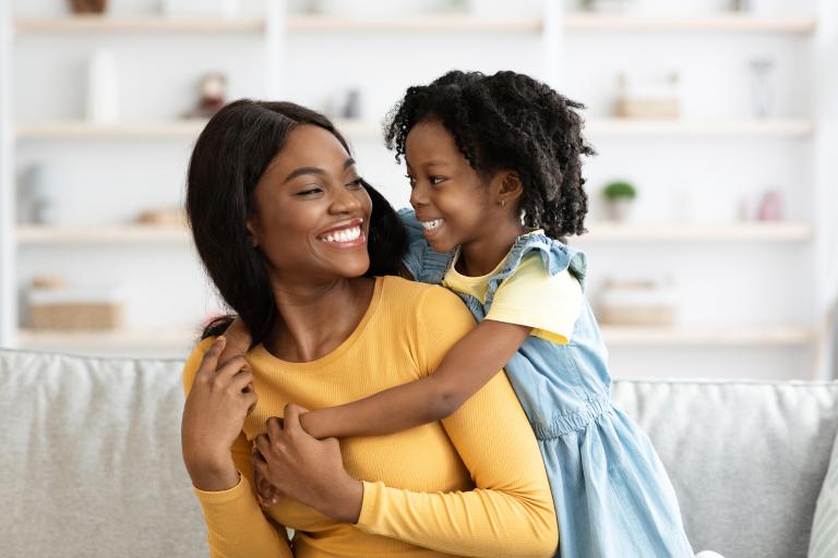 mother and daughter hugging and smiling