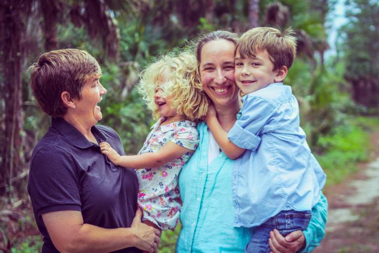 2 women and their children in the woods